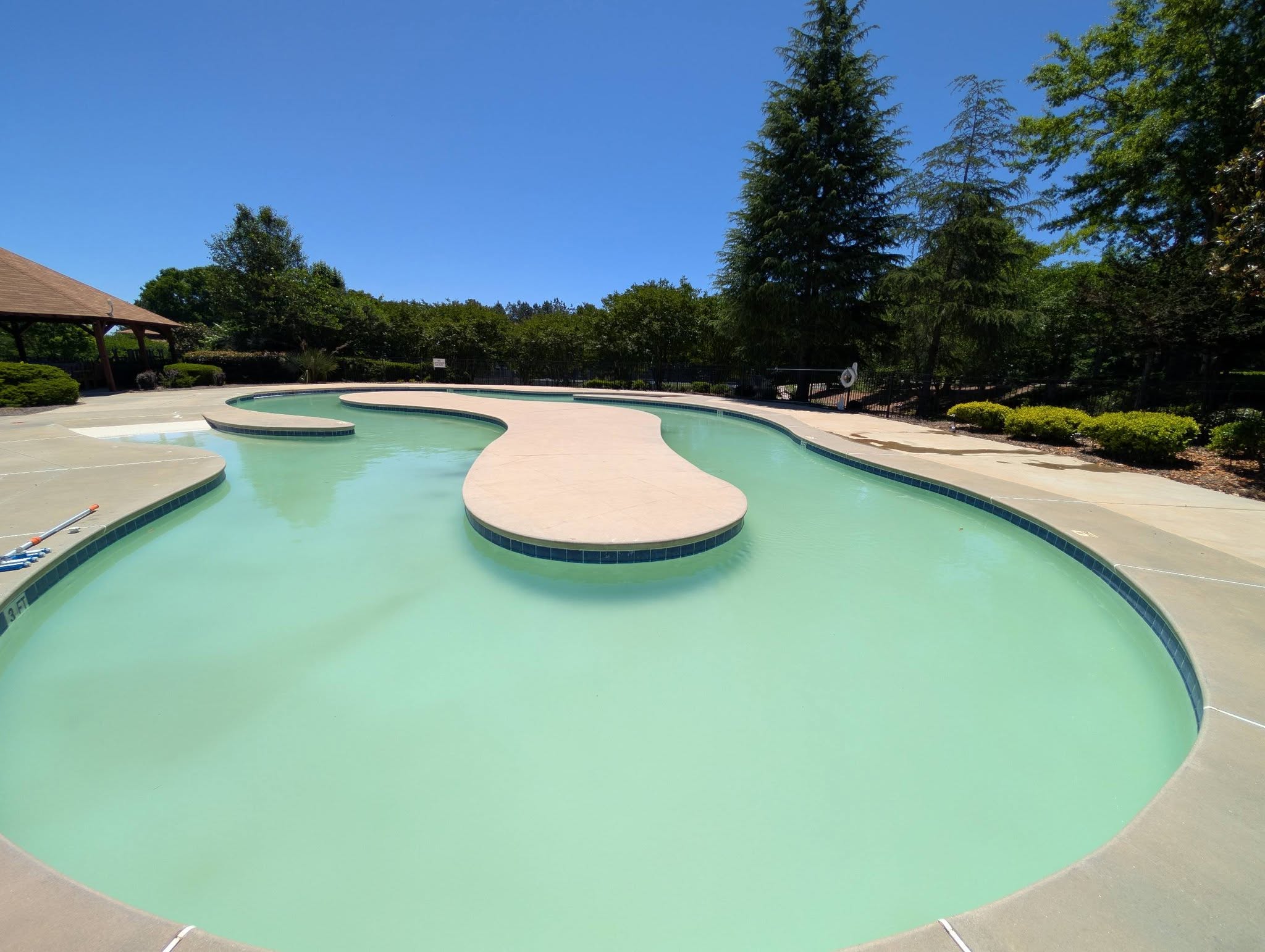Community lazy river pool cleaned and maintained by Peachy Pools