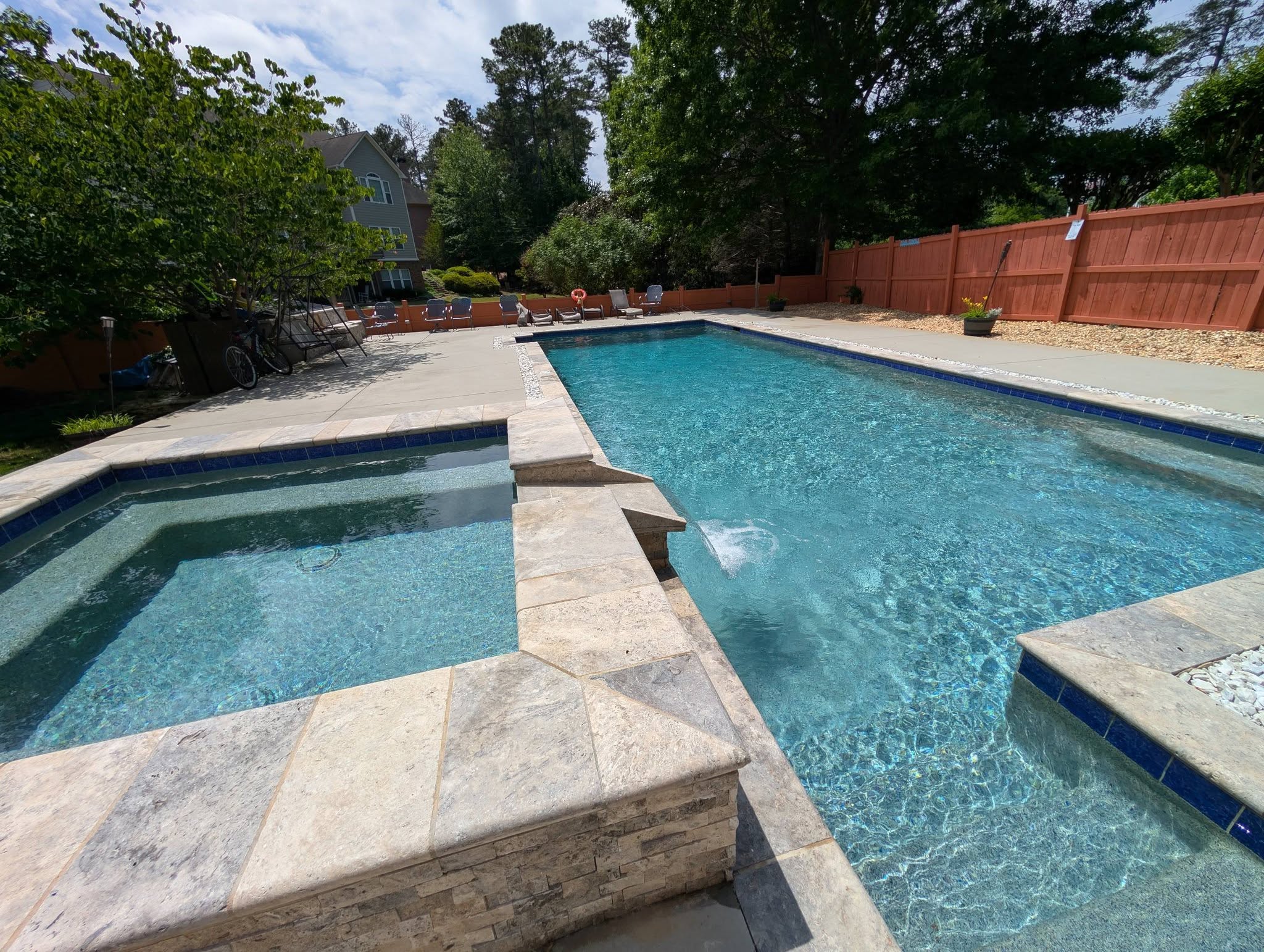 Residential pool with spa and water feature maintained by Peachy Pools